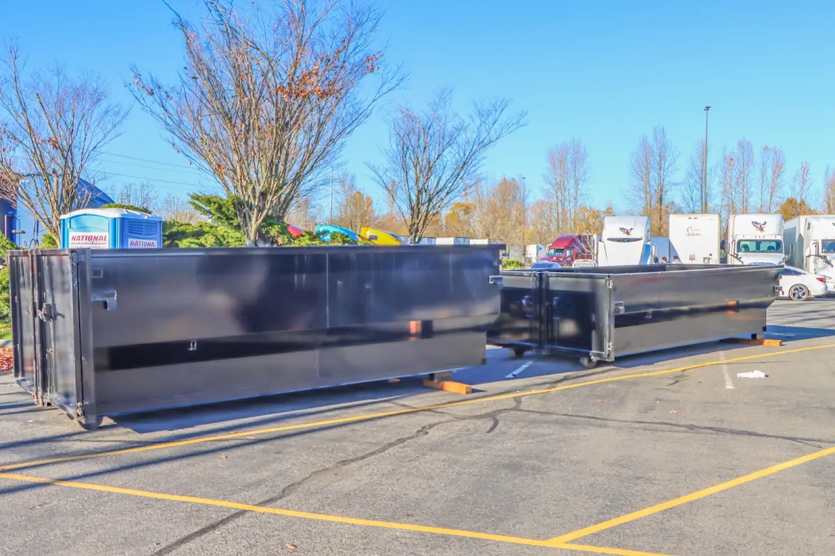 Professional dumpster rental service with roll-off container on residential driveway in North Salem